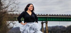 Gaby Laurent poses in front of a bridge