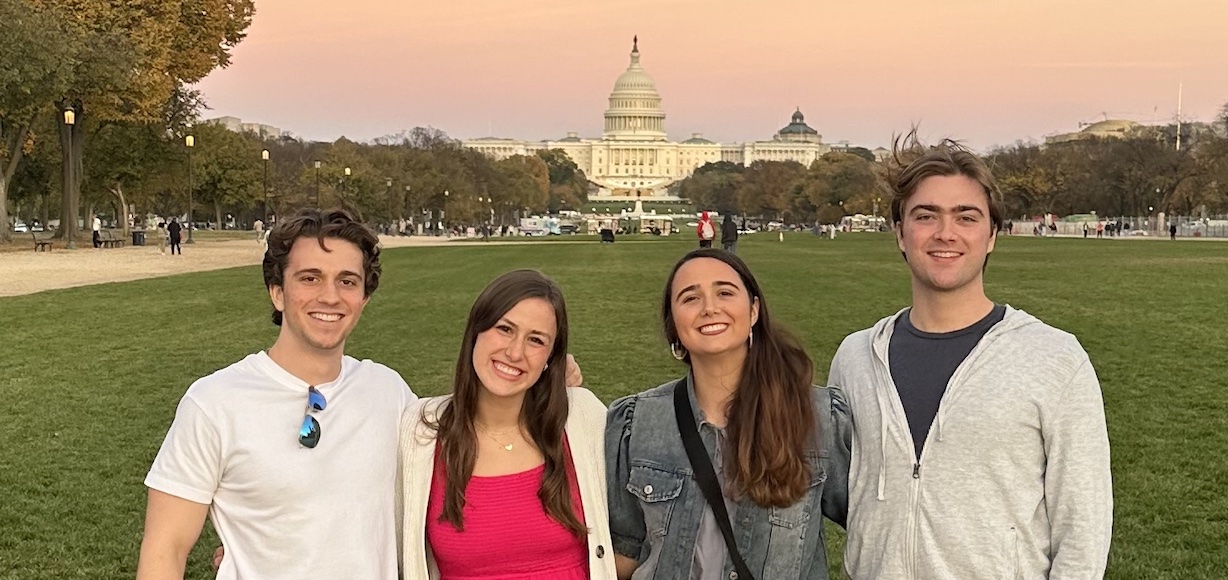 four young adults posing on the Mall in Washington, D.C.