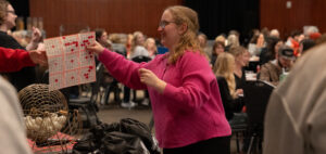 A bingo player shows her winning game card