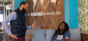 Keon Williams Jr. talks to a customer at his Tacos4Life location in the Dillworth neighborhood, Charlotte, N.C. All the decor is made by people in the countries that are served by Feed My Starving Children (FMSC).