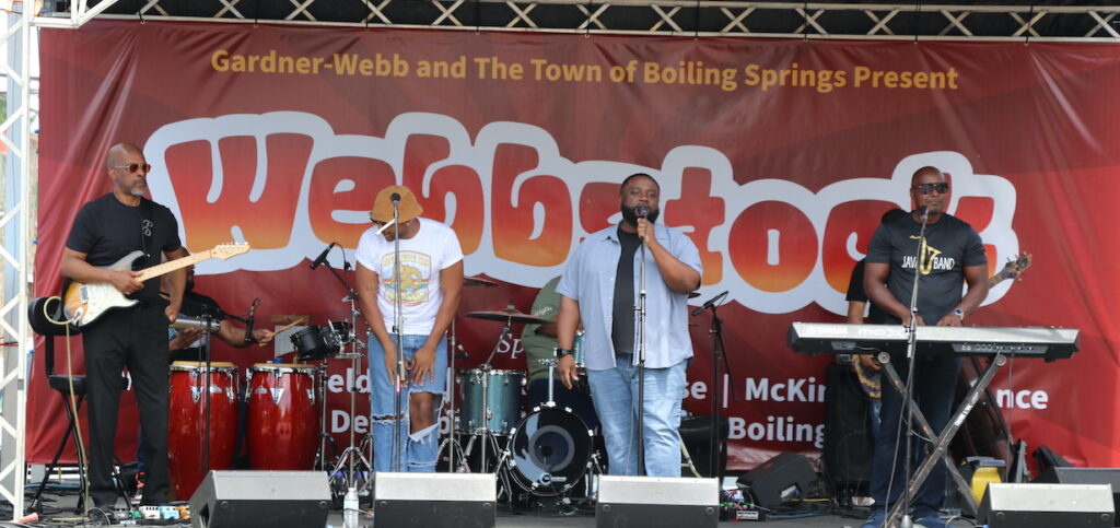 a band performs on the webbstock main street stage