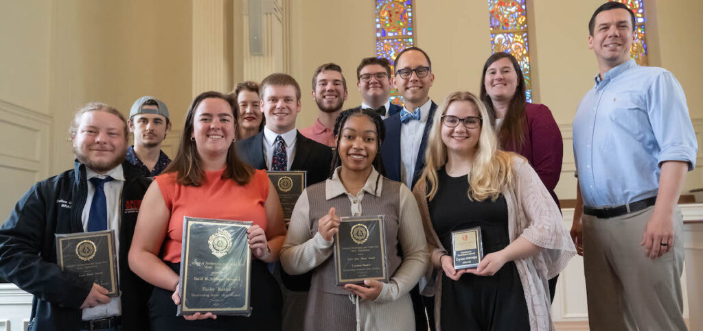 Students holding their awards