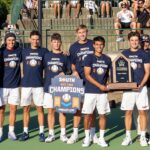 The men's tennis team poses after winning the Big South Conference.
