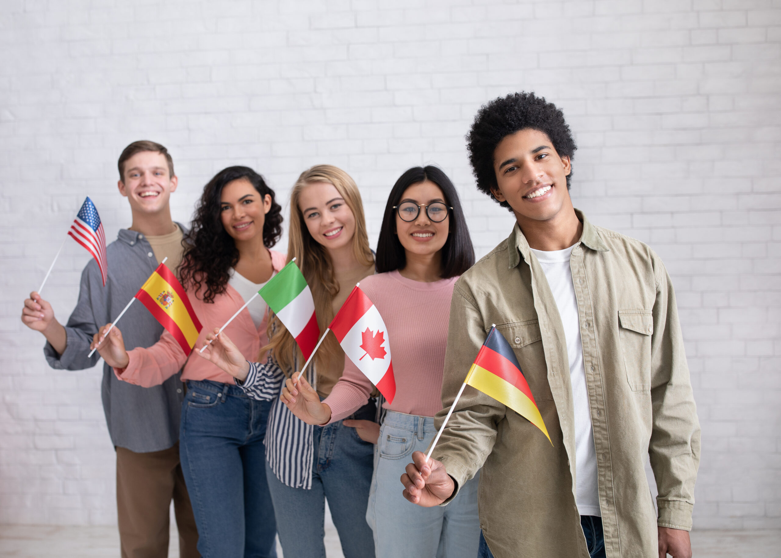 college students standing and holding flags