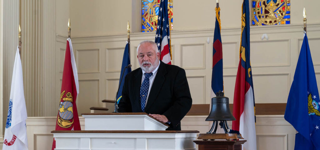 Speaker with service flags, American and N.C. flags