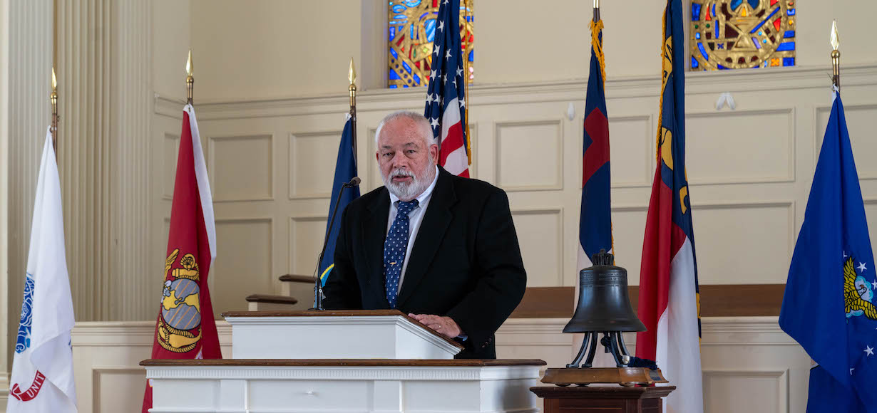 Speaker with service flags, American and N.C. flags