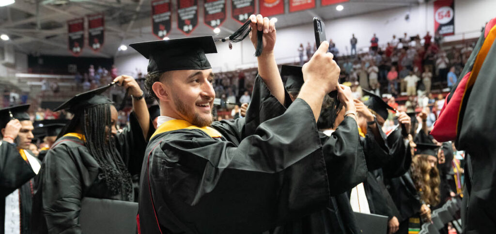 A graduate turns his tassel