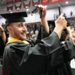 A graduate turns his tassel