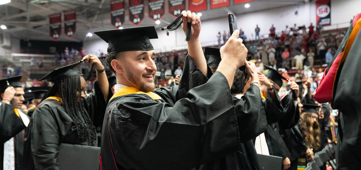 A graduate turns his tassel