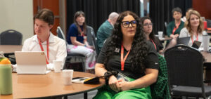 Attendees listen to conference presentations
