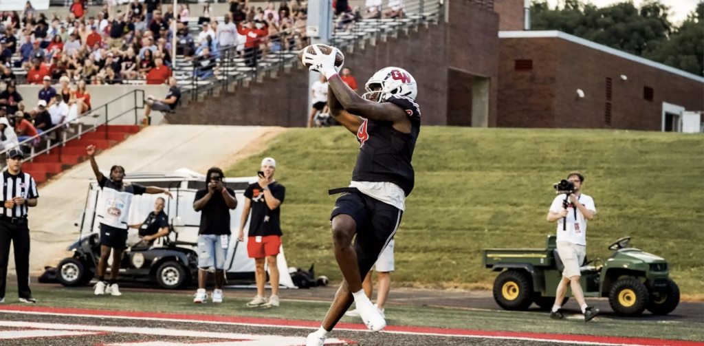 Football player makes a catch at the end zone