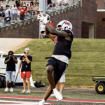 Football player makes a catch at the end zone