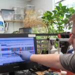 Caleb Hill points to a DNA sequence on a computer screen