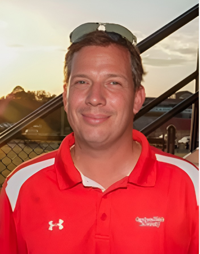 Will Corn on athletic field in red GWU polo