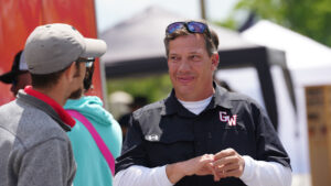Will Corn talking to staff on campus