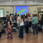 A group of teachers participate in a music literacy workshop
