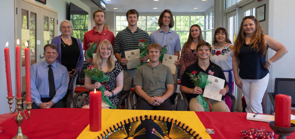 Students and professors pose at the Sigma Delta Pi induction ceremony