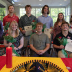 Students and professors pose at the Sigma Delta Pi induction ceremony