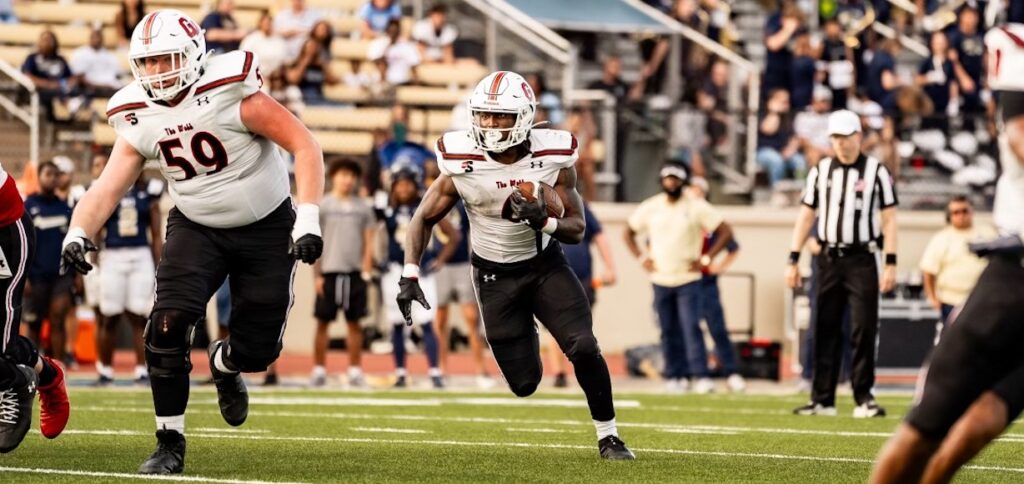 football players run across the field