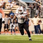 football players run across the field
