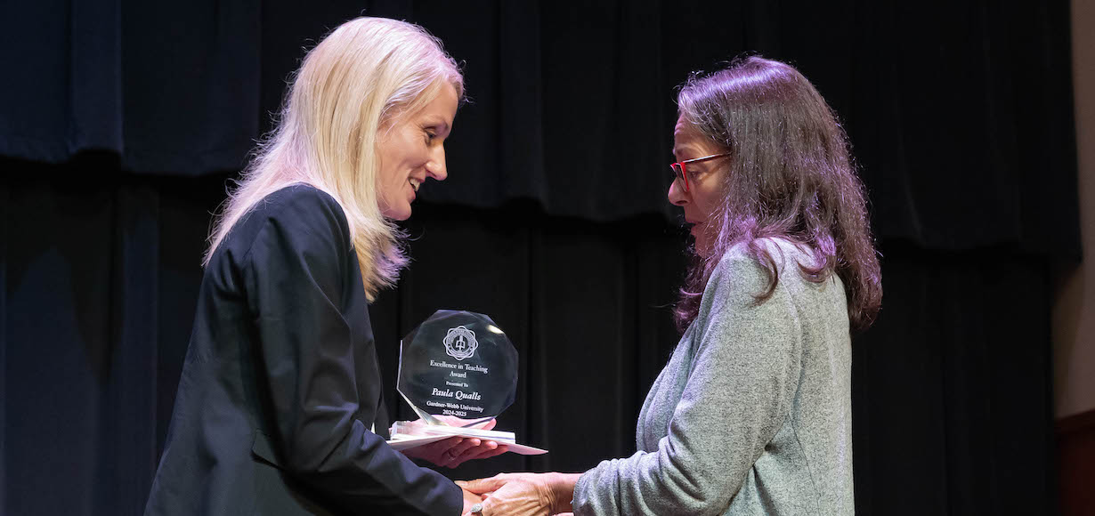 Interim Provost and Vice President of Academic Affairs Dr. Nicole Waters congratulates Professor of Religious Studies Dr. Paula Qualls on receiving the Excellence in Teaching Award.