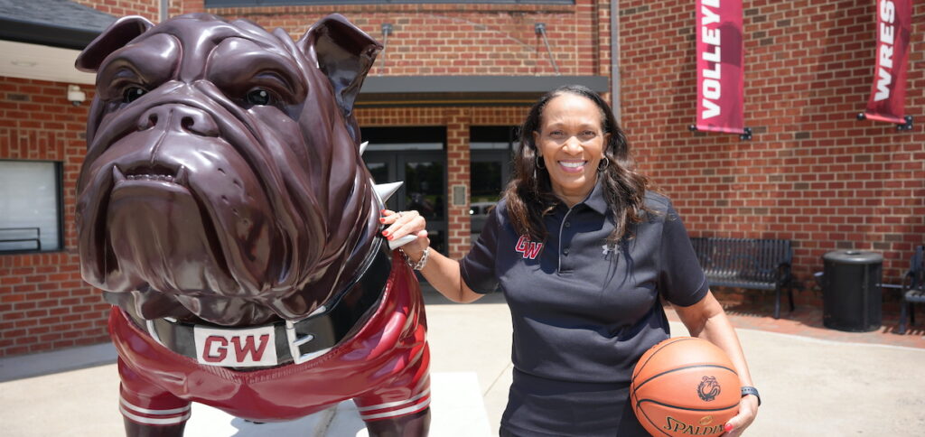 Terri Williams posing with bulldog statue at Lutz-Yelton Convocation Center