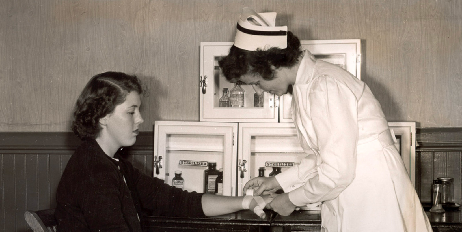 black and white photo of nurse treating person