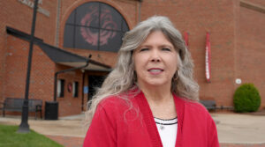 Pam Scruggs standing in front of building