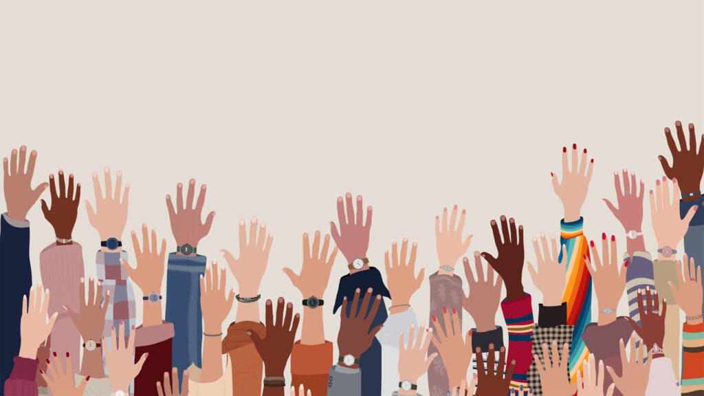 hands lifted in the air of many different races and genders