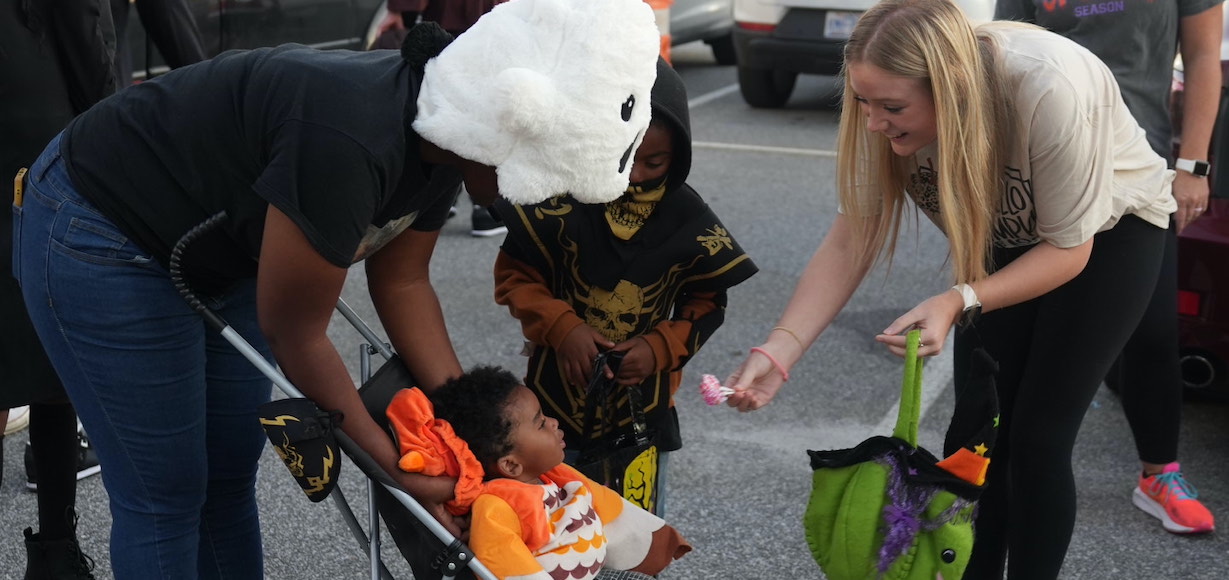 A baby receives candy from a lady