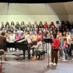 a group photo of the elementary and middle school choirs