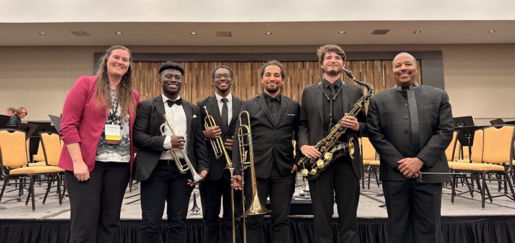 band members pose at the conference