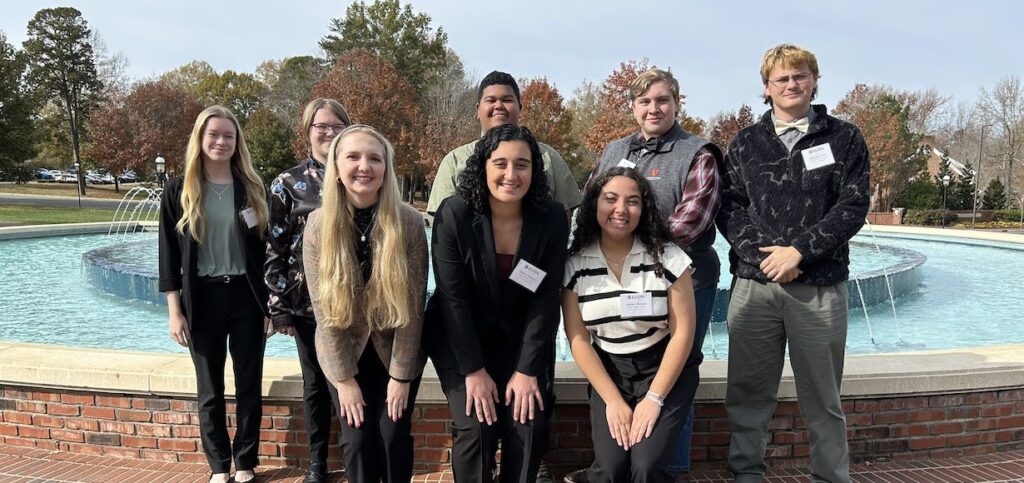 The group of researchers pose for a photo at the symposium