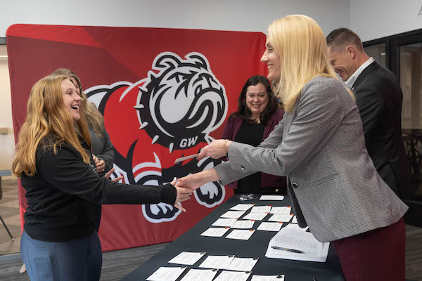 Dr. Nicole Waters presents a student with an academic honor.