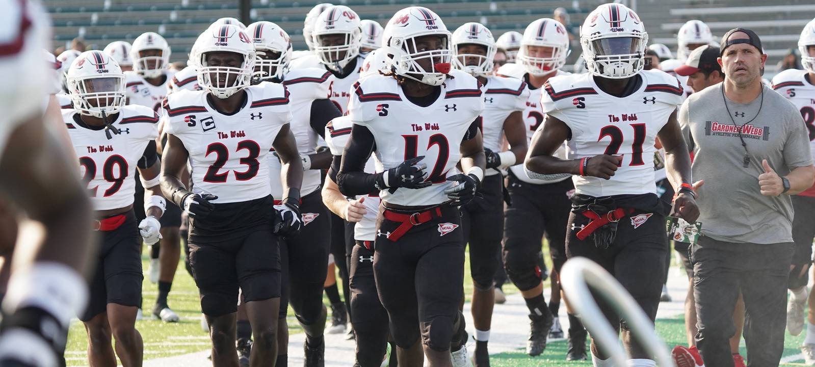 Football team enters the stadium on game day.