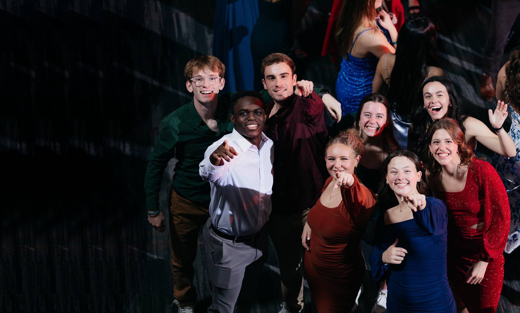 Students smiling looking up at the camera.