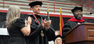 Nate Evans after receiving the president's medal with Brittany Evans and Lamont Littlejohn