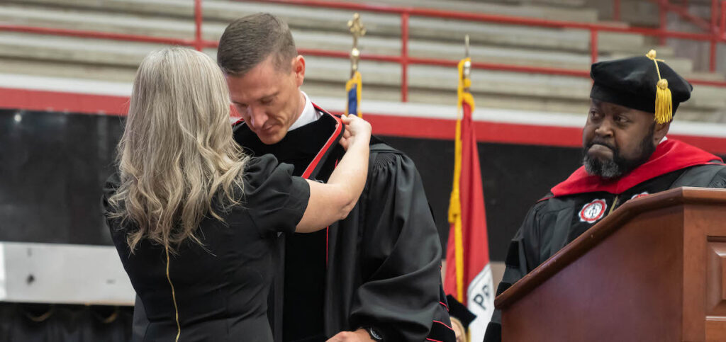 Brittany Evans Bestows the president's medal on Gardner-Webb s 14th president Nate Evans