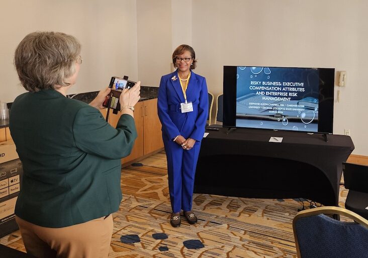 Linda takes Stephanie's picture at conference