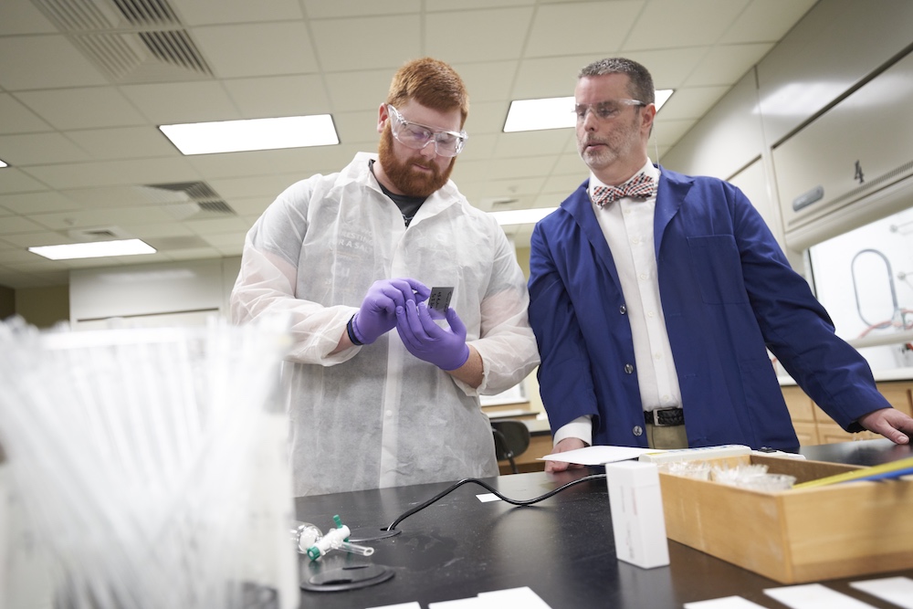 Professor Ben Brooks with a student in the chemistry lab