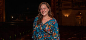 Shelby Putnam alumna poses inside Carolina Theater.