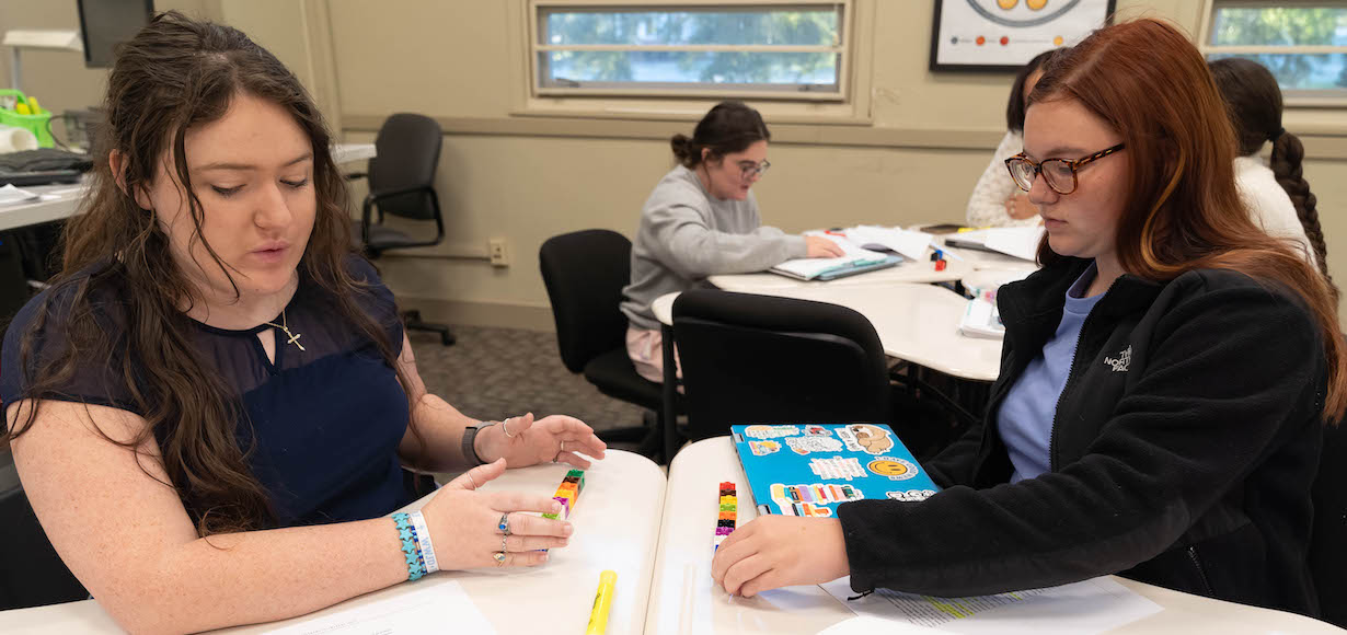 students practice an activity in a literacy education classroom.