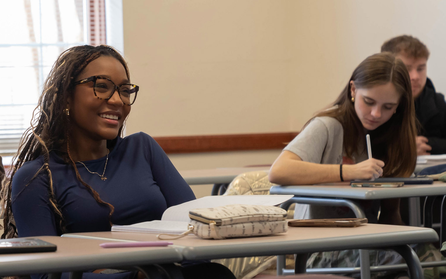 smiling student in a classroom