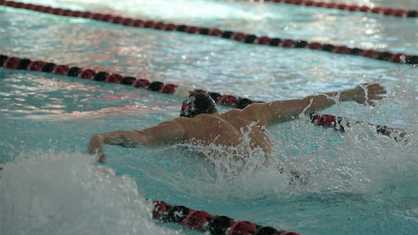ale student on swim team in the pool.