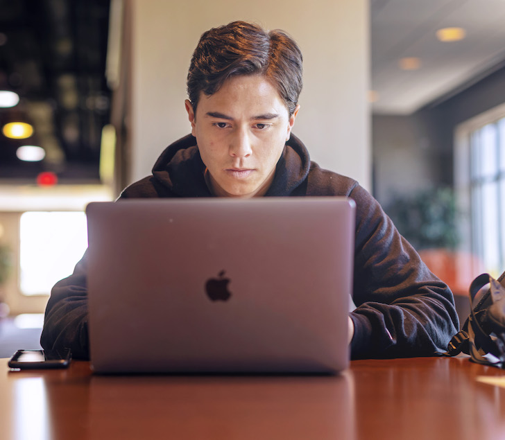 student writing on computer