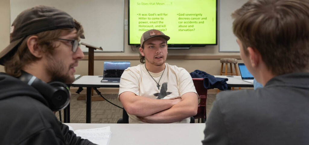 Jackson Hartley, center, in Theology Class