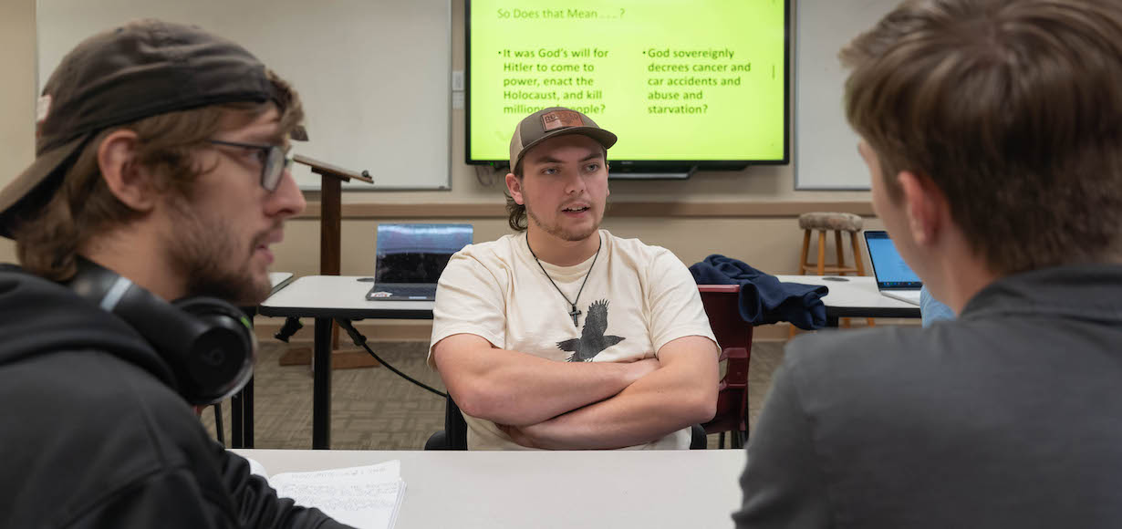 Jackson Hartley, center, in Theology Class