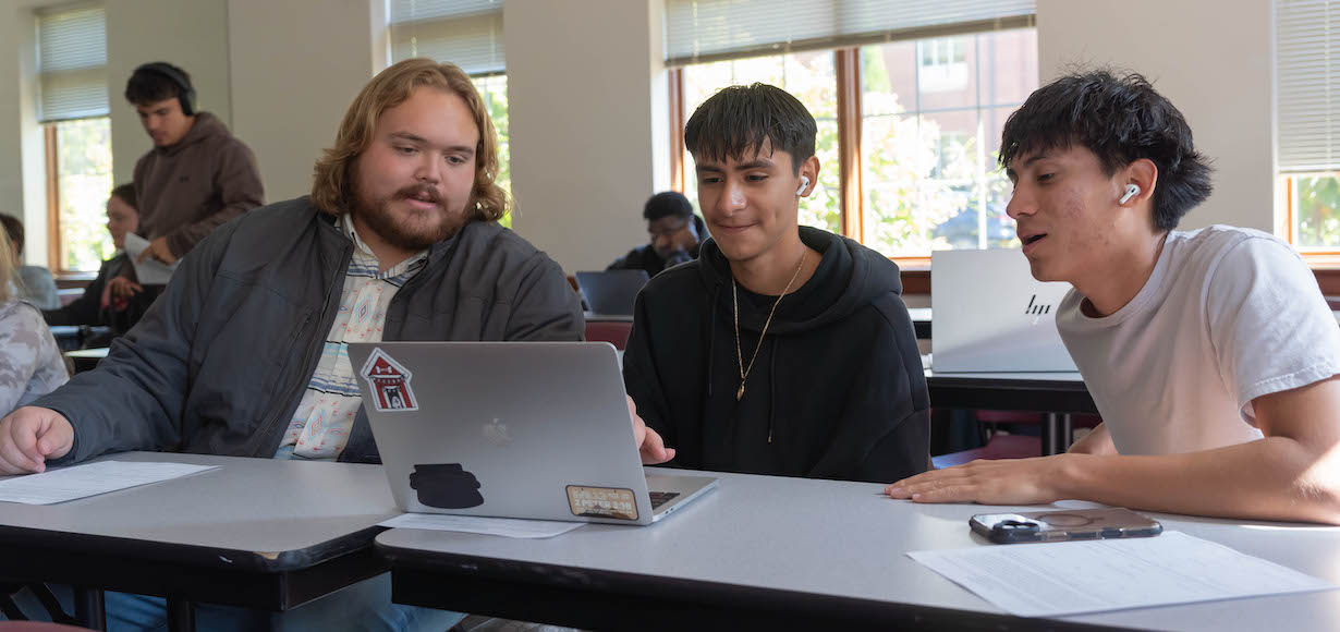 Wade Gross, left, Peer Leader, talks to students in the first-year experience class.